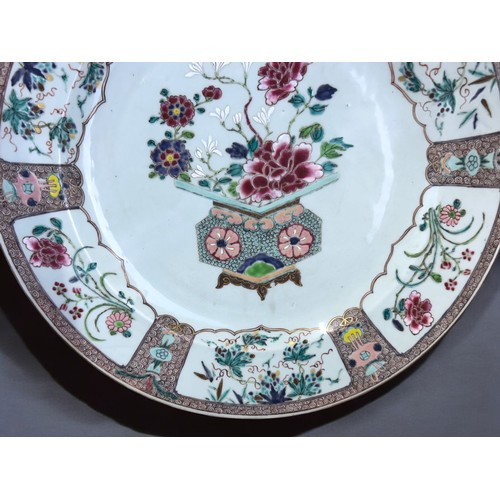 36 - A large Chinese porcelain Famille rose charger.Yongzheng/Qianlong, 18th Century.Enamels painted bask... 