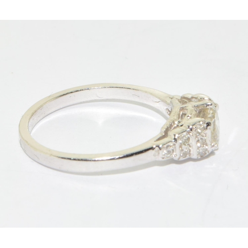 156 - 18ct white gold Diamond set ring the central stone flanked by graduated diamond shoulders size M