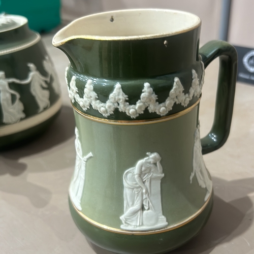 201 - Antique Green Jasperware carltonware teapot and jug set, featuring classical relief design. Marked 