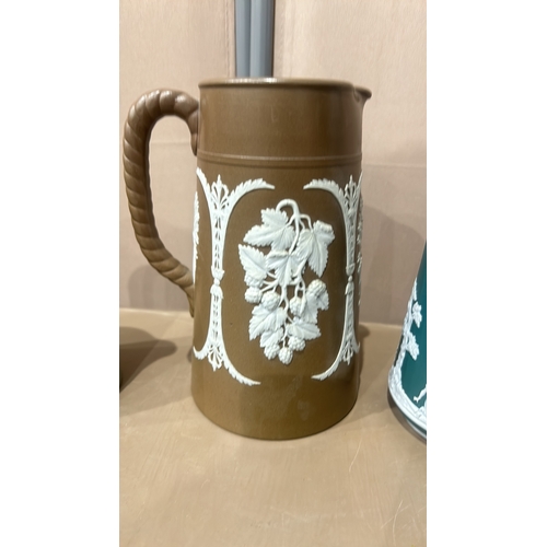 202 - Dudson Brothers stoneware jug, featuring green and white relief with archery scene, twisted handle. ... 