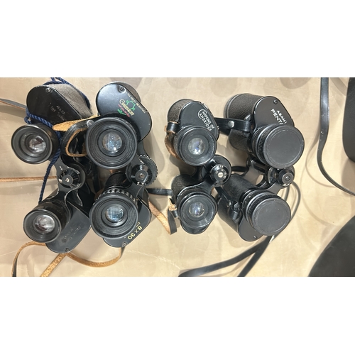 371 - Collection of vintage binoculars, various models, with leather cases. Brands include Greenkat and Mi... 