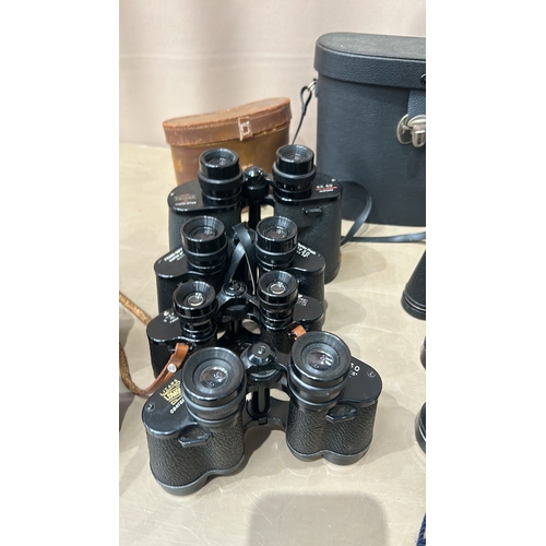 371 - Collection of vintage binoculars, various models, with leather cases. Brands include Greenkat and Mi... 