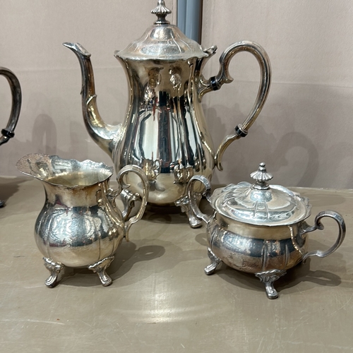 380 - Antique silver plate tea set with ornate detailing, includes various teapots, a sugar bowl, a cream ... 