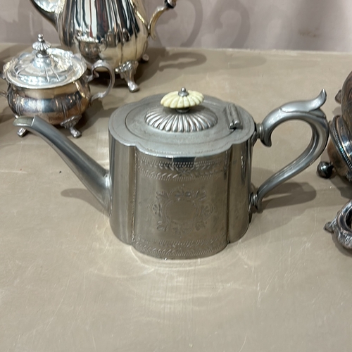 380 - Antique silver plate tea set with ornate detailing, includes various teapots, a sugar bowl, a cream ... 