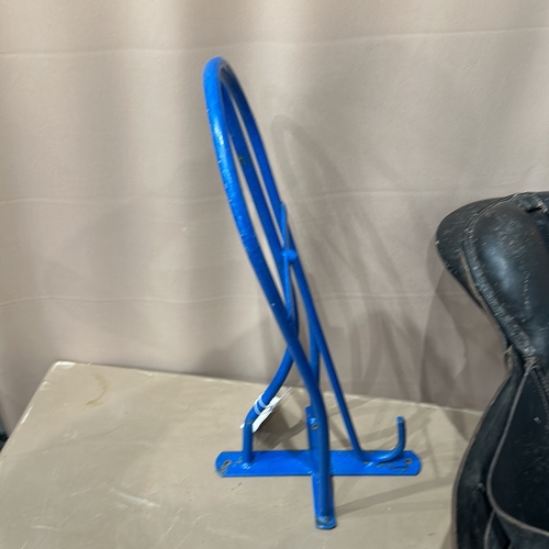 384 - blue metal Wall Mounted Saddle stand with vintage black leather saddle