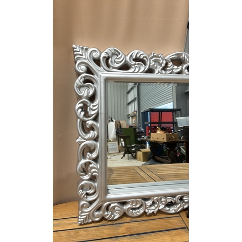 161 - Large ornate silver-colored mirror with intricately carved floral frame, modern design.