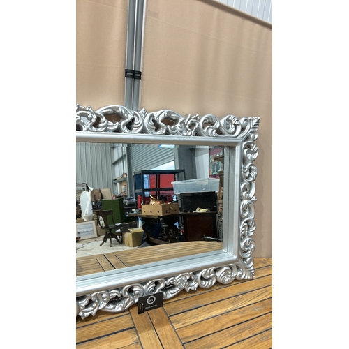 161 - Large ornate silver-colored mirror with intricately carved floral frame, modern design.