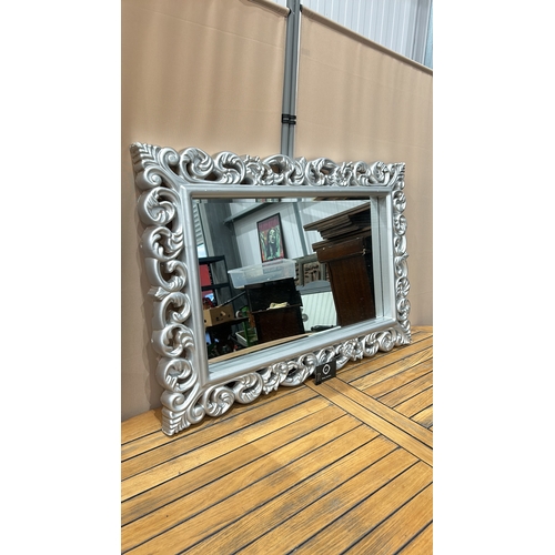 161 - Large ornate silver-colored mirror with intricately carved floral frame, modern design.