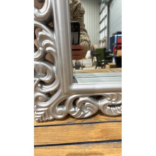 161 - Large ornate silver-colored mirror with intricately carved floral frame, modern design.