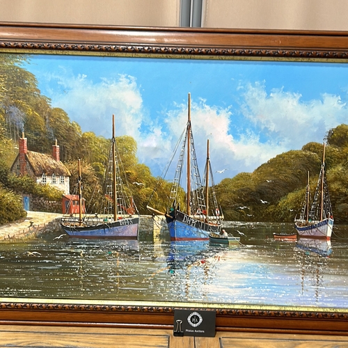 189 - Oil painting depicts a serene harbor scene with moored boats, framed in a carved wooden frame. Artis... 