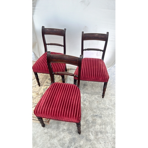 113 - Set of three Regency mahogany dining chairs featuring spiral turned supports and red striped velvet ... 