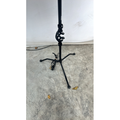 359 - A Tall Black metal floor lamp with tripod base, with intricate design. Good Condition