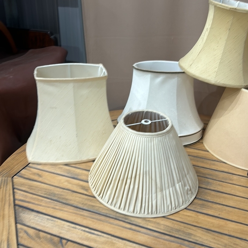 353 - Assorted fabric lampshades, various styles and sizes. Includes pleated and bell-shaped designs.