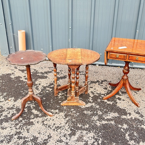 100 - Antique mahogany occasional table with drop leaves and two drawers, featuring a turned pedestal base... 