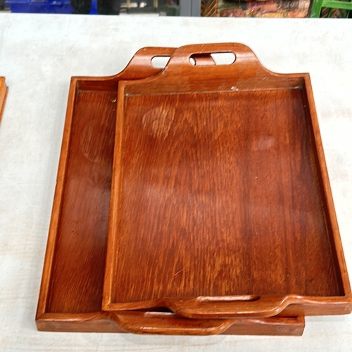 338 - Set of 5 wooden trays with carved handles, showcasing rich, warm tones and smooth surfaces. 2 sets g... 