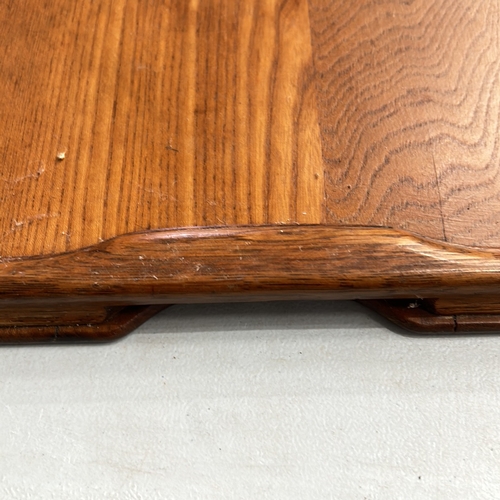 339 - Two Antique oak serving trays, rectangular and oval, featuring brass handles and smooth edges.