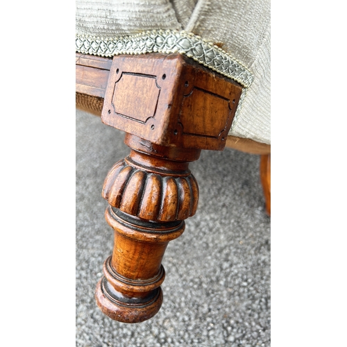 106 - Victorian-style button-tufted chair with carved mahogany legs. Elegant design with plush upholstery.