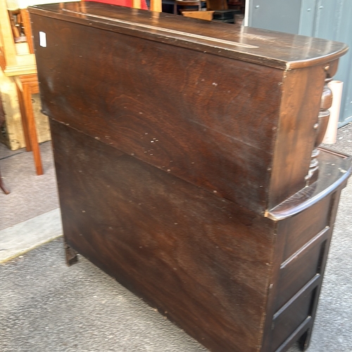 61 - Ercol dark wood sideboard features carved columns and paneled doors, offering ample storage. Ercol