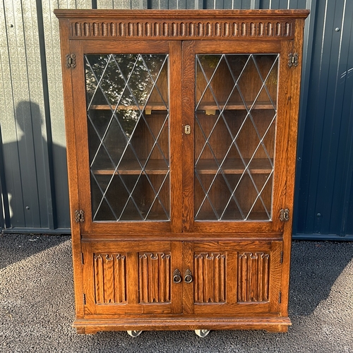 62 - Oak Art Nouveau bookcase with leaded glass doors, featuring carved decorative motifs from the early ... 