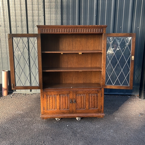 62 - Oak Art Nouveau bookcase with leaded glass doors, featuring carved decorative motifs from the early ... 