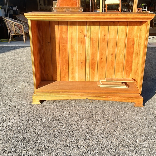 64 - Solid pine bookcase with natural finish, featuring adjustable shelves. Robust construction and class... 