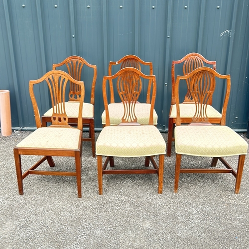 69 - Set of six mahogany dining chairs, featuring shield-back design and upholstered seats. From the Geor... 