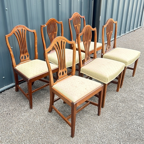 69 - Set of six mahogany dining chairs, featuring shield-back design and upholstered seats. From the Geor... 