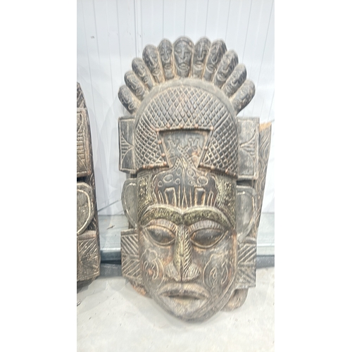 243 - Carved wooden tribal mask with intricate detailing, showcasing multiple faces and geometric patterns... 