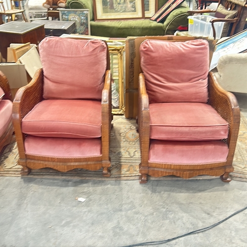 71 - bergere Arm Chairs featuring plush coral pink upholstery, displaying elegant carved wooden details.