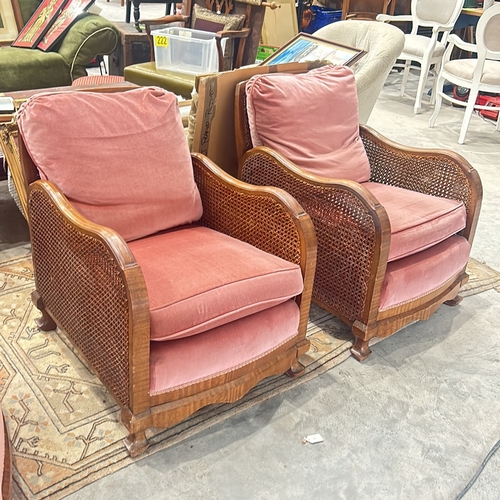 71 - bergere Arm Chairs featuring plush coral pink upholstery, displaying elegant carved wooden details.