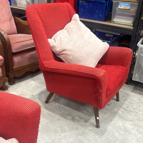 74 - Pair of Mid-Century Modern red upholstered armchairs with wooden legs, showcasing classic design ele... 