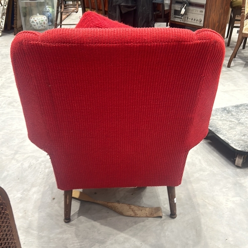 74 - Pair of Mid-Century Modern red upholstered armchairs with wooden legs, showcasing classic design ele... 