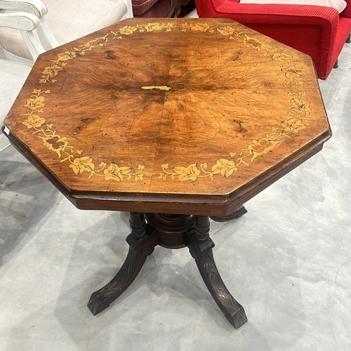 77 - Victorian walnut octagonal table features intricate marquetry inlay on top and elegant turned legs.