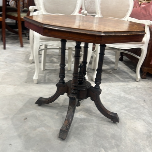 77 - Victorian walnut octagonal table features intricate marquetry inlay on top and elegant turned legs.