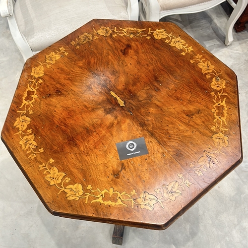 77 - Victorian walnut octagonal table features intricate marquetry inlay on top and elegant turned legs.