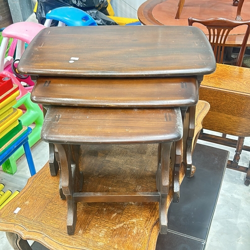 81 - Set of three Ercol vintage nesting tables in dark wood, featuring curved edges and sturdy constructi... 