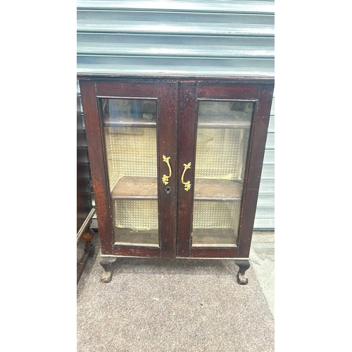 85 - Mahogany display cabinet with glass doors and brass handles, featuring cabriole legs from the early ... 