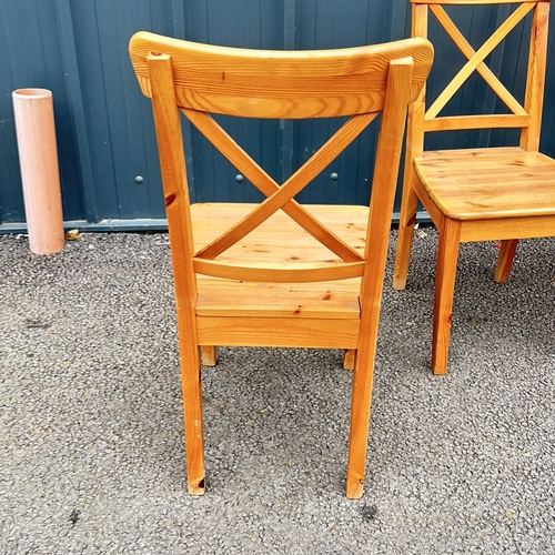 86 - Set of 4 Pine Wooden chairs with a natural finish, featuring a classic cross-back design and sturdy ... 