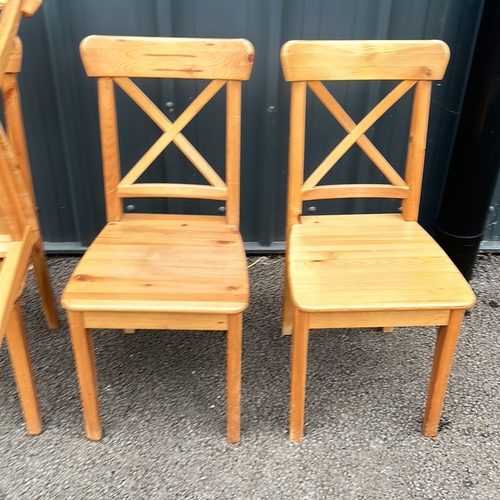 86 - Set of 4 Pine Wooden chairs with a natural finish, featuring a classic cross-back design and sturdy ... 