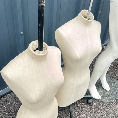 88 - Set of two dressmaker's mannequins with adjustable stands, accompanied by a mannequin lower half.