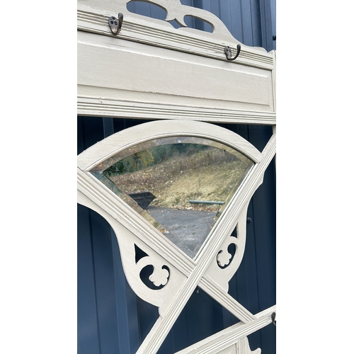 90 - Victorian wooden hall stand with mirror features intricate scrollwork and a distressed cream finish.... 