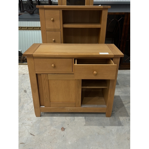 103 - Contemporary oak sideboard with sliding doors and shelving, featuring two drawers and minimalist des... 