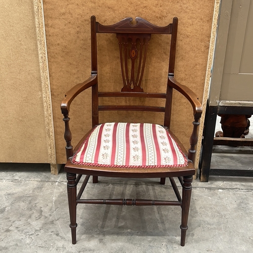 94 - Victorian mahogany armchair with intricate back detailing and upholstered seat.