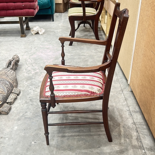 94 - Victorian mahogany armchair with intricate back detailing and upholstered seat.