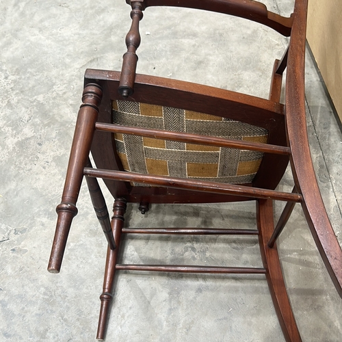 94 - Victorian mahogany armchair with intricate back detailing and upholstered seat.