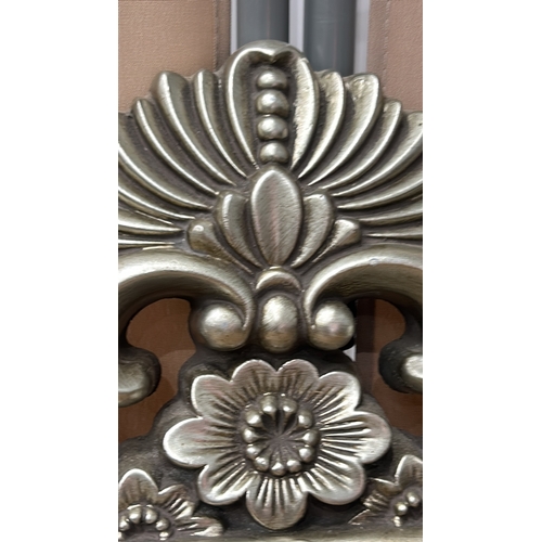 158 - Ornate silver-toned wall mirror with intricate floral design. Rectangular shape. Dimensions approxim... 