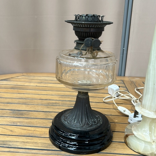 346 - Pair of onyx table lamps with brass fittings, accompanied by a vintage glass oil lamp with decorativ... 