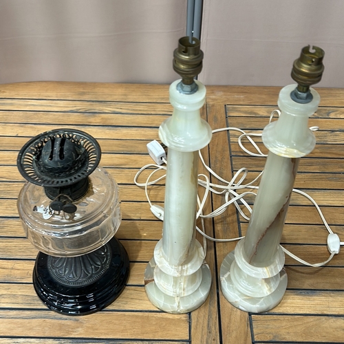 346 - Pair of onyx table lamps with brass fittings, accompanied by a vintage glass oil lamp with decorativ... 