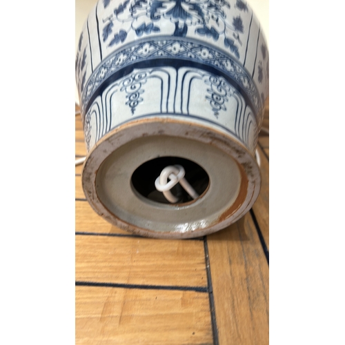 349 - Large Blue and white Chinese Ming Style ceramic lamp with floral motifs and a beige shade. It featur... 