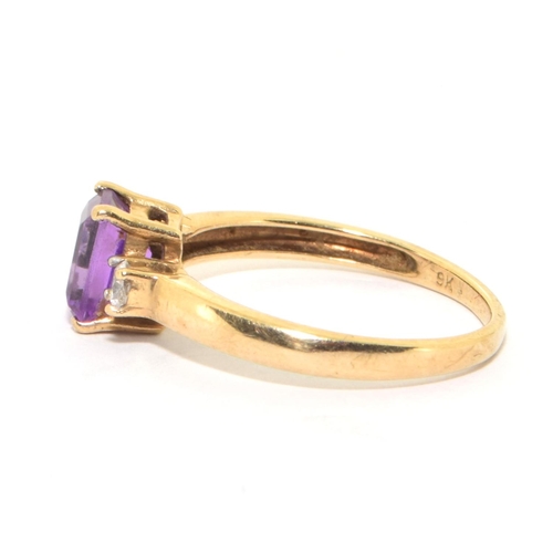 141 - 9ct gold ladies good emerald cut Amethyst solitaire with clear stone decoration size P